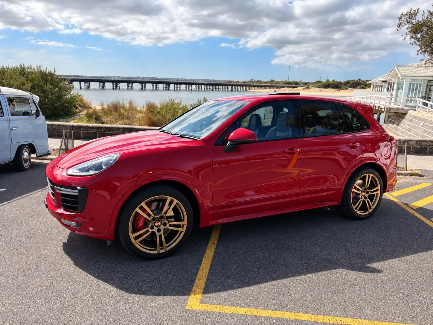 Carmine Red Porsche Cayenne GTS overlooking the Barwon Heads Bridge